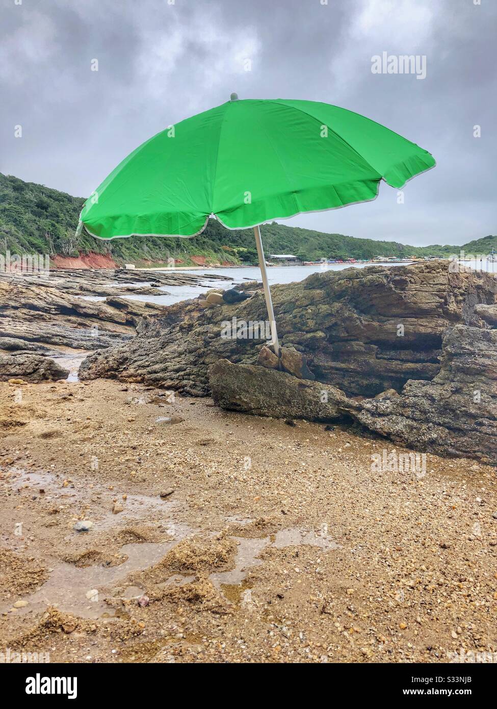 A green sun umbrella on the beach. Stock Photo