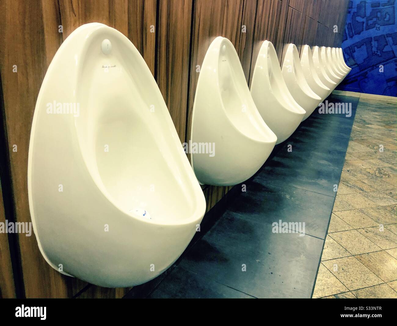 Row of urinals in a male toilet Stock Photo Alamy