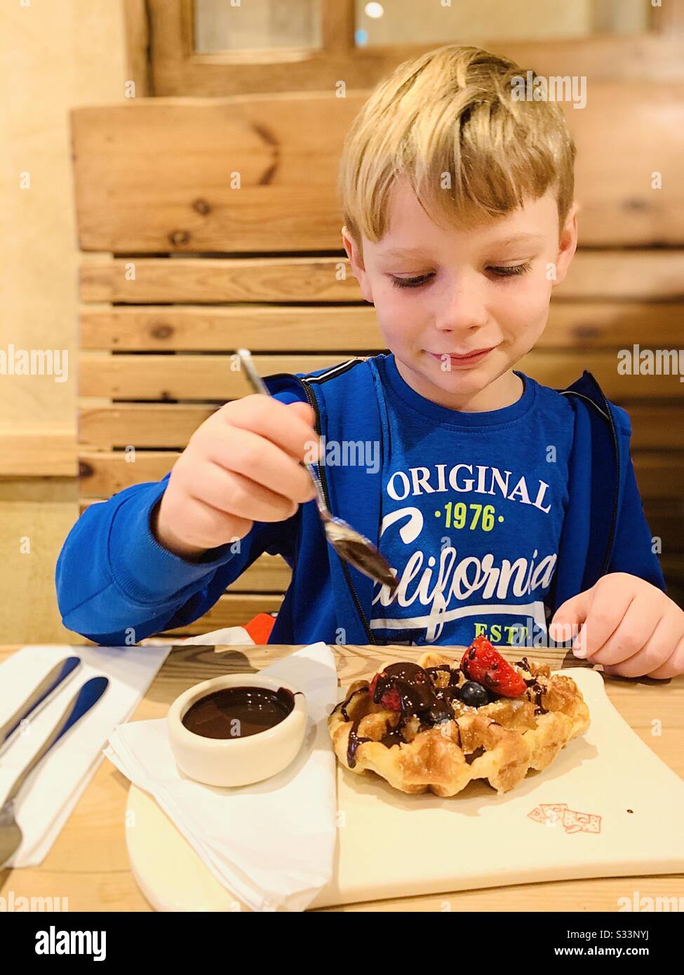 Boy eating chocolate waffles - Smartphone Captured Stock Image