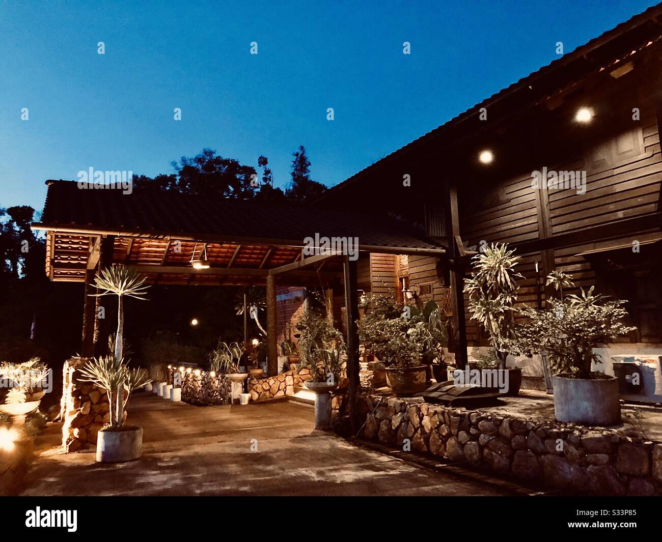 Luxury House Vacation with warm lights: Brown Wooden Old House In the Evening Feb14 19:41P.M. Malaysia Stock Photo