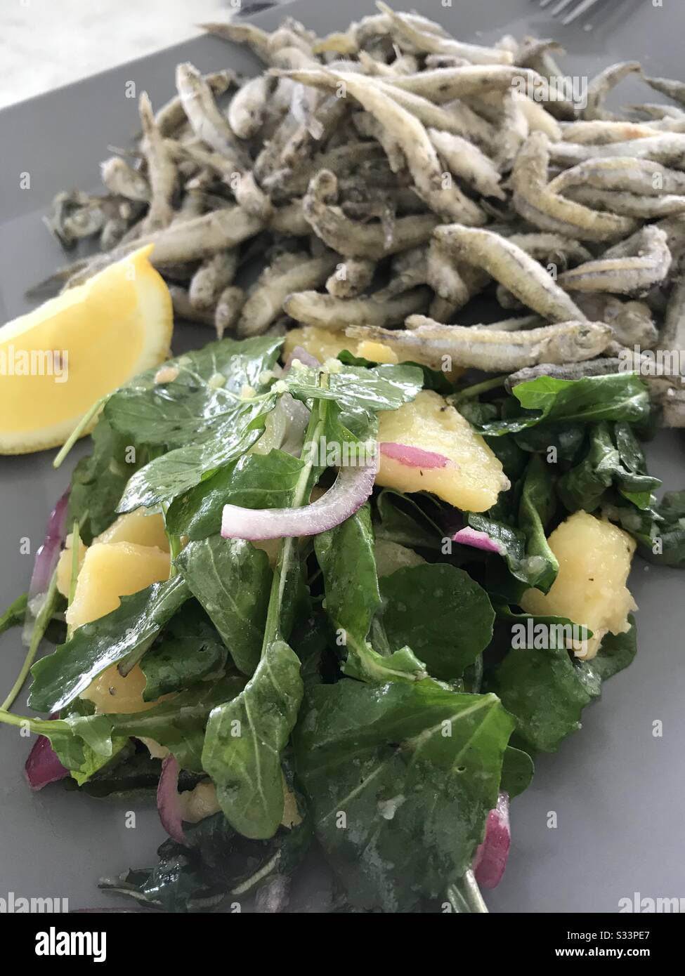 Mediterannean sea food (smelts) dish with vegetables in Sun City restaurant in Split, Croatia - Smartphone Captured Stock Image