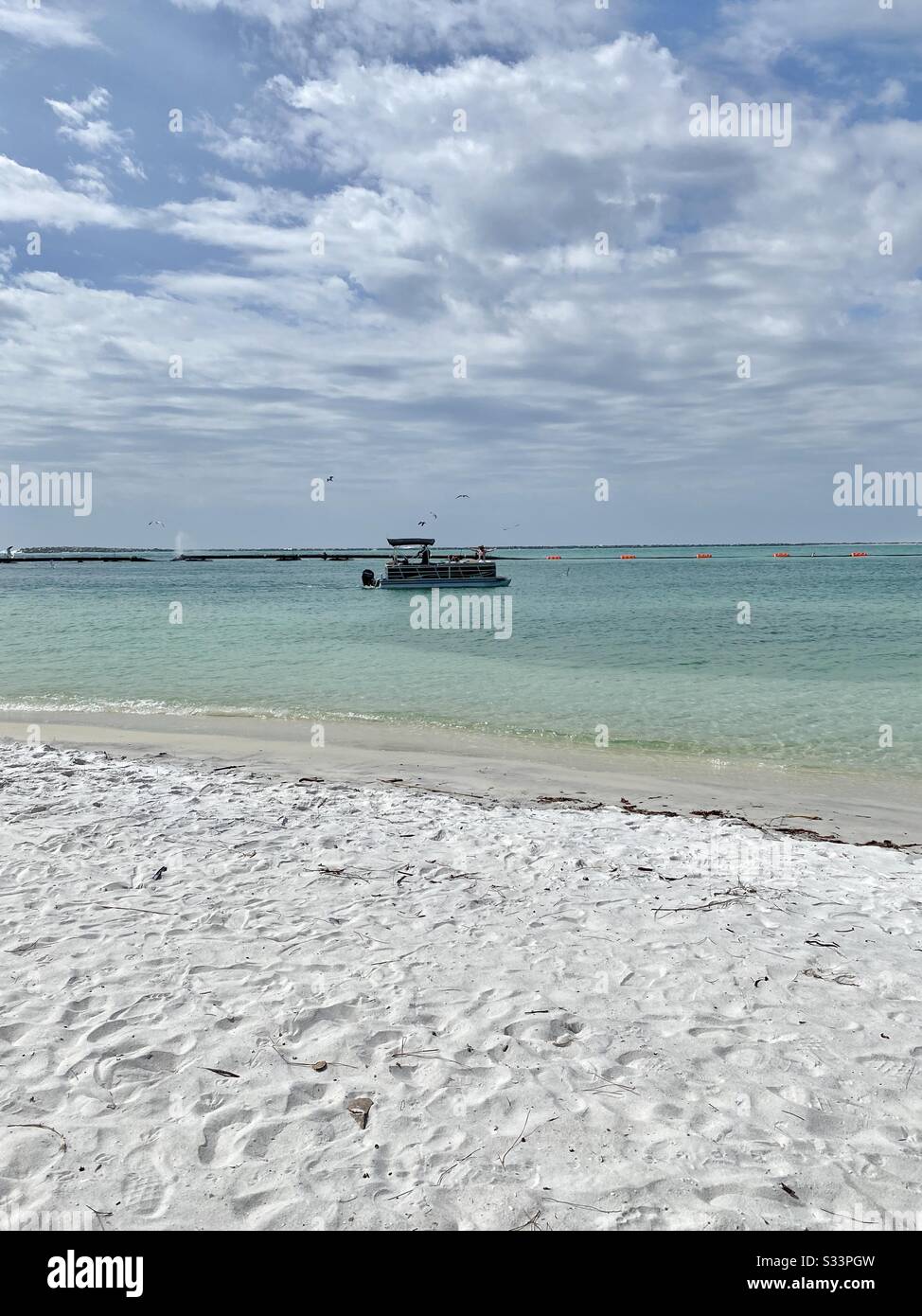 Pontoon boat trolling across the water on the Gulf of Mexico - Smartphone Captured Stock Image