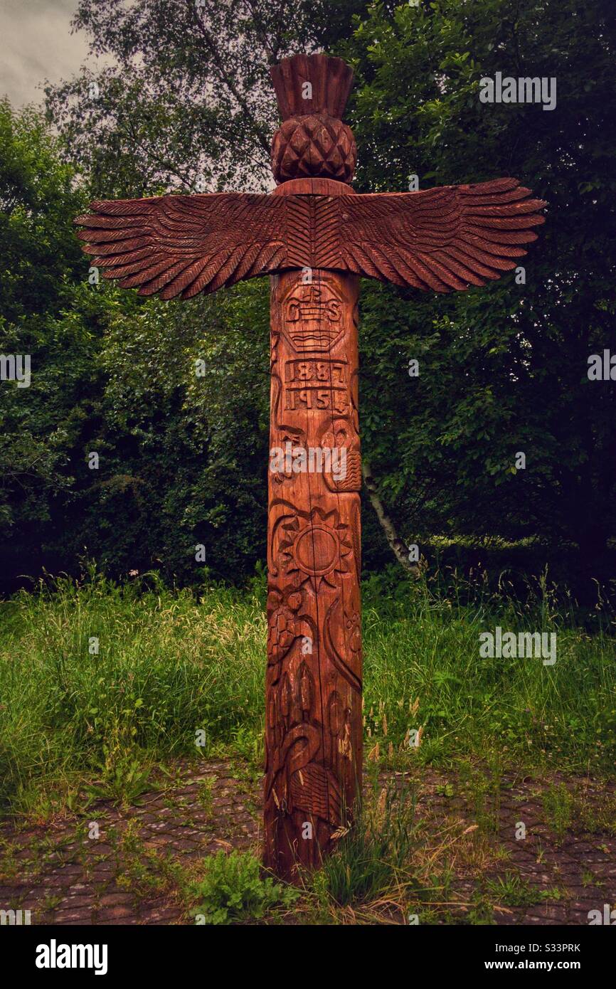 Twelve foot high totem pole in the Saltings nature conservation area in Old Kilpatrick. It is covered in designs based on local history and wildlife by pupils from Gavinburn Primary School. - Smartphone Captured Stock Image