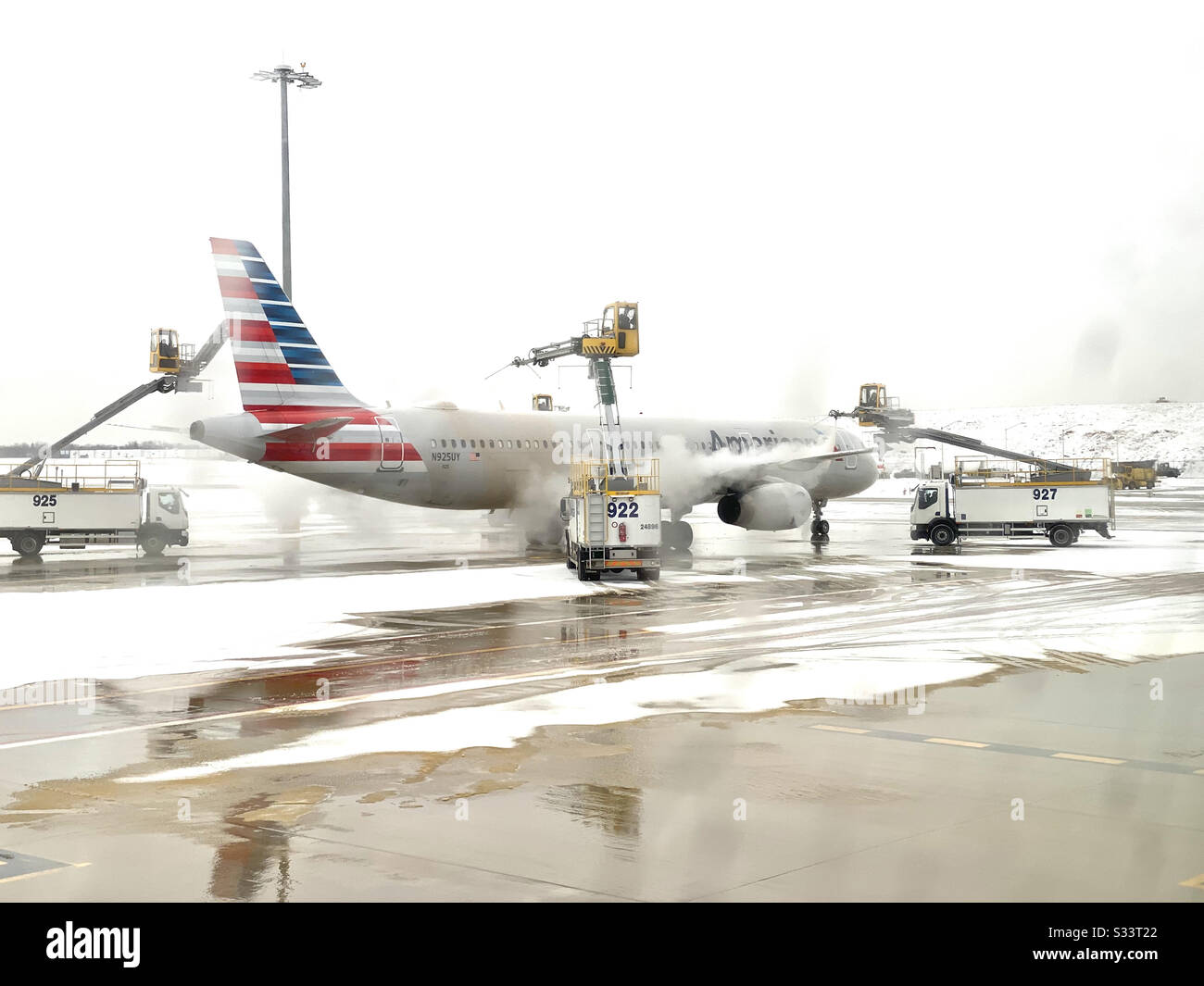 Deicing of American Airlines airplane. Stock Photo