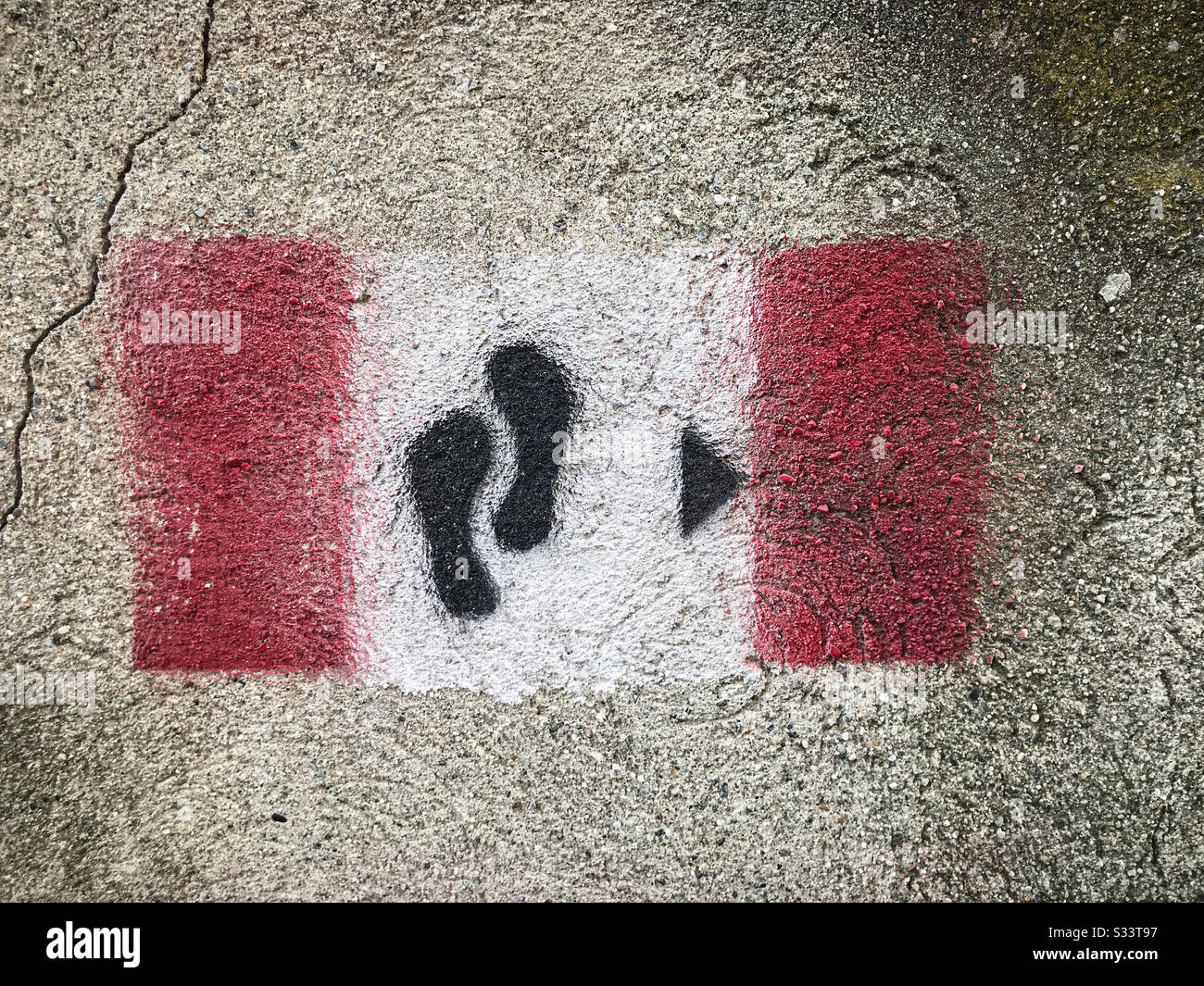 Red, white and black Via Francigena sign painted on pavement. - Smartphone Captured Stock Image