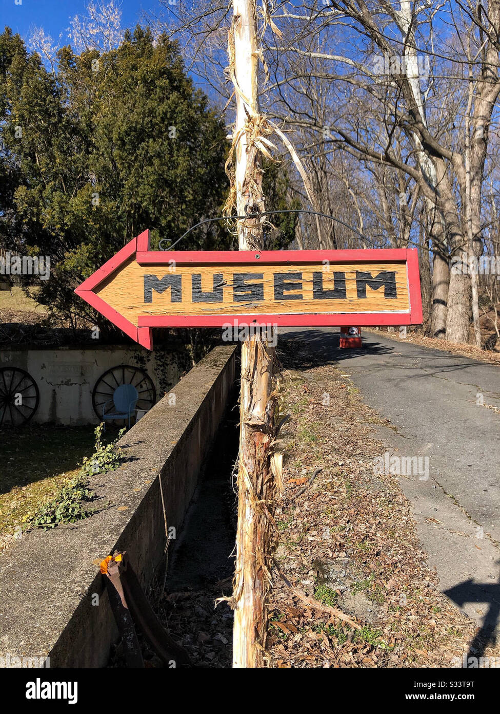 Hand made hand painted sign on rustic bark covered wooden pole Museum sign - Smartphone Captured Stock Image
