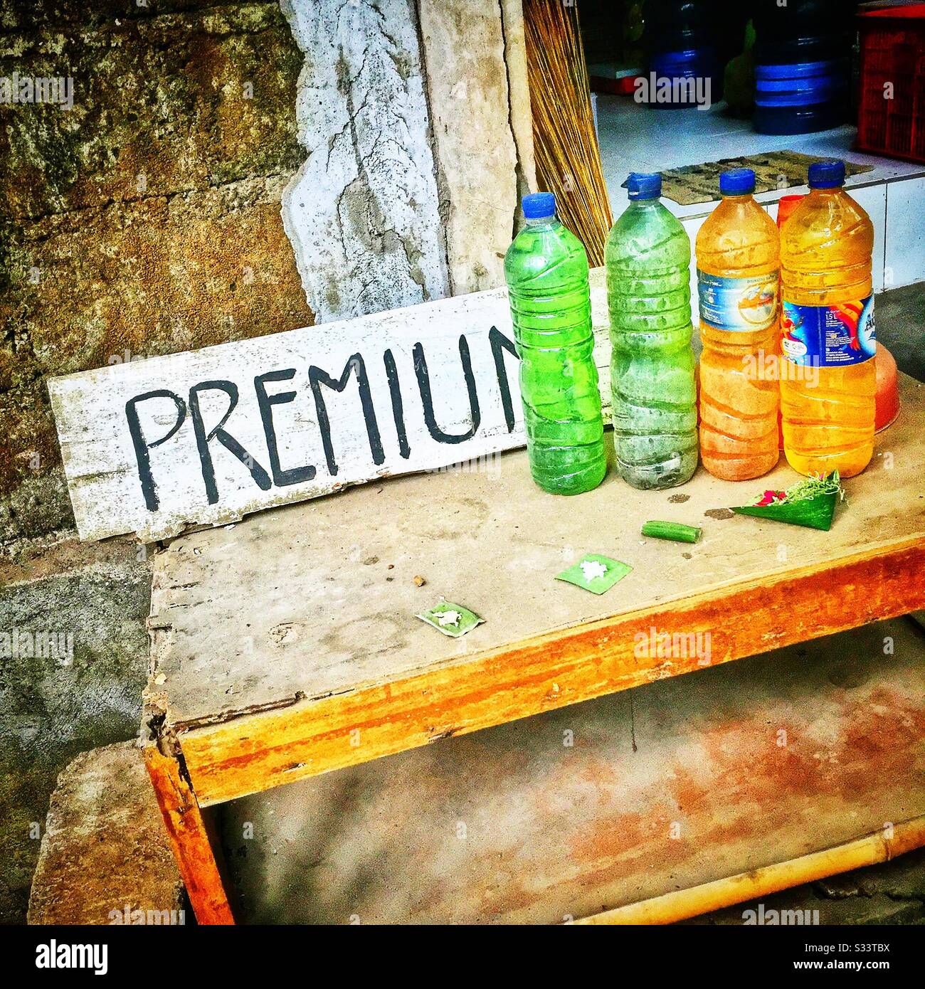 Petrol for sale in reused plastic water bottles, Candidasa, Bali, Indonesia - Smartphone Captured Stock Image