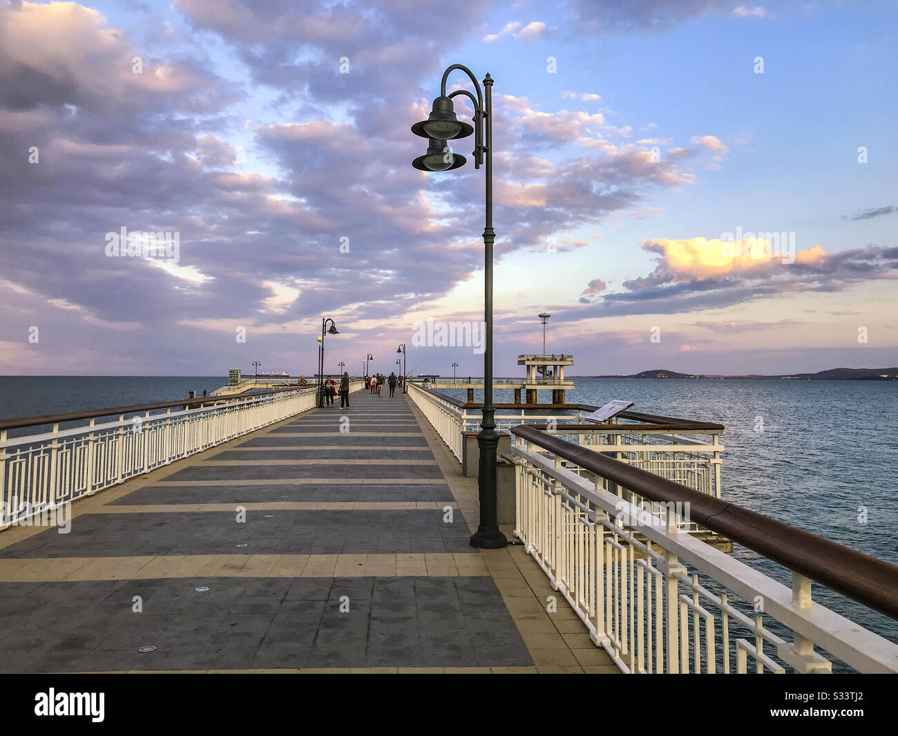 Colorful sunset over the sea bridge in Burgas bay, Bulgaria. Black Sea landscape. - Smartphone Captured Stock Image