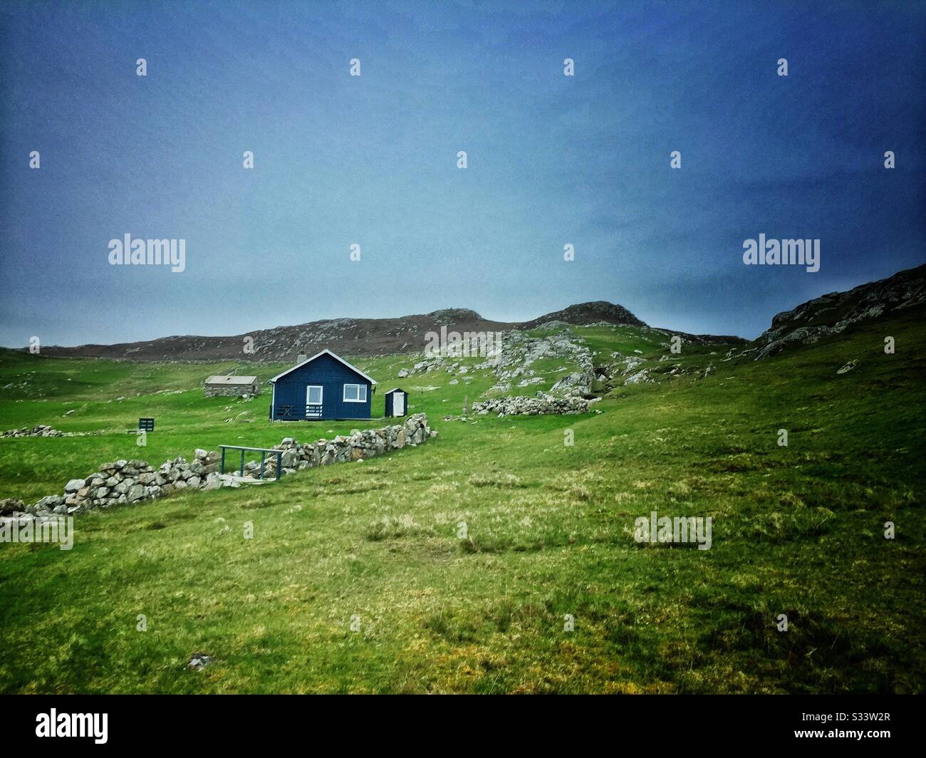 Blue cabin in a remote area of Shetland Island Stock Photo