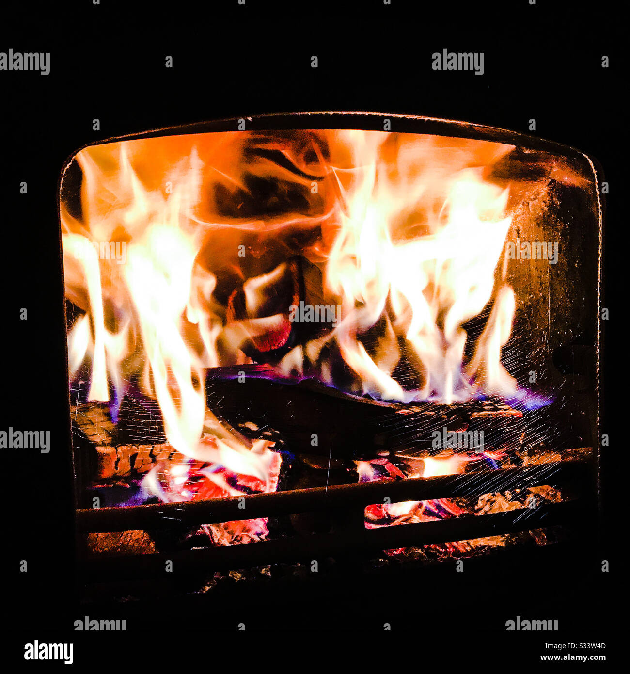 Roaring fireplace wood burner alight providing heat Stock Photo