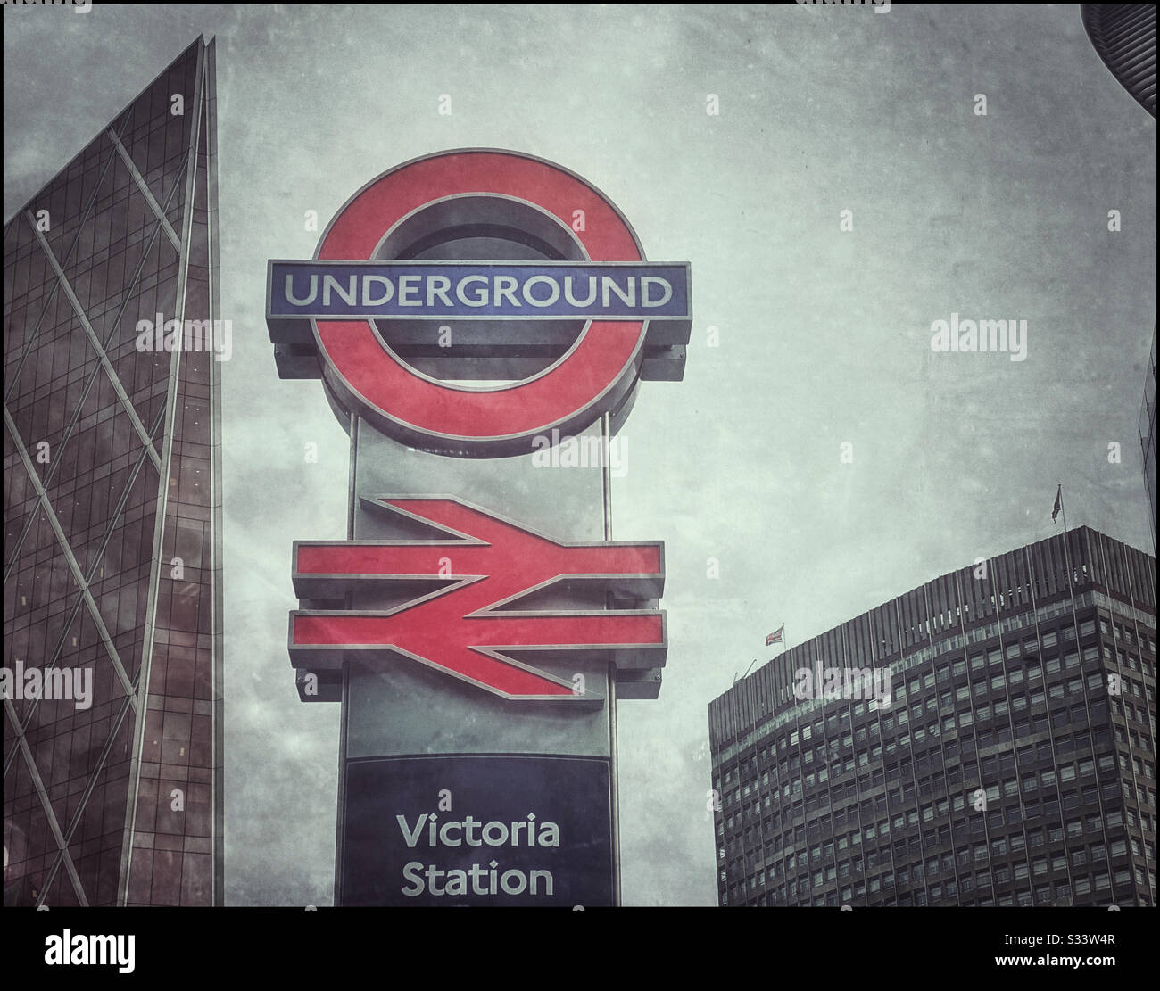 A grunge effect image of the iconic London Underground & British Rail logos at Victoria Station in central London, England. Photo Credit - © COLIN HOSKINS. - Smartphone Captured Stock Image