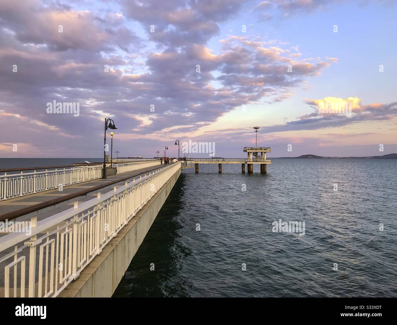 Colorful sunset over the sea bridge in Burgas bay, Bulgaria. - Smartphone Captured Stock Image