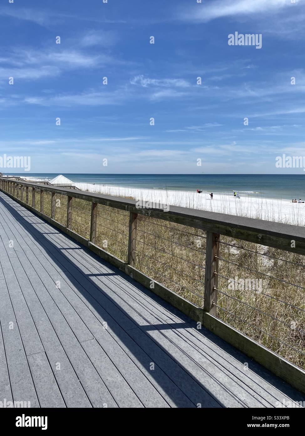 Upper view from walkway of white sand beach and Gulf of Mexico emerald water - Smartphone Captured Stock Image