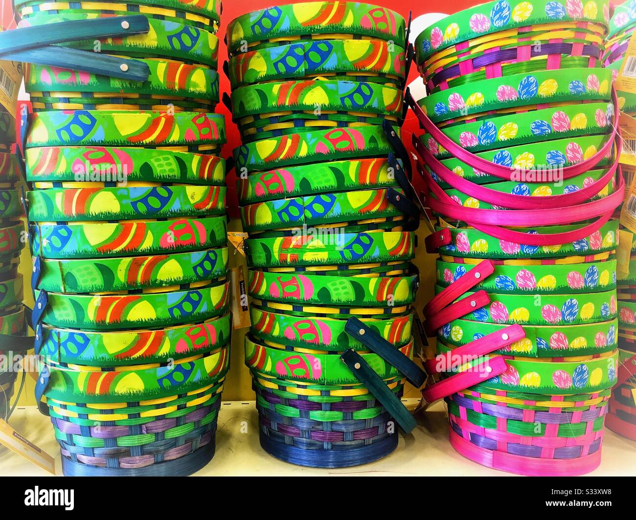 Stacks of colourful Easter baskets in a craft store, UK Stock Photo