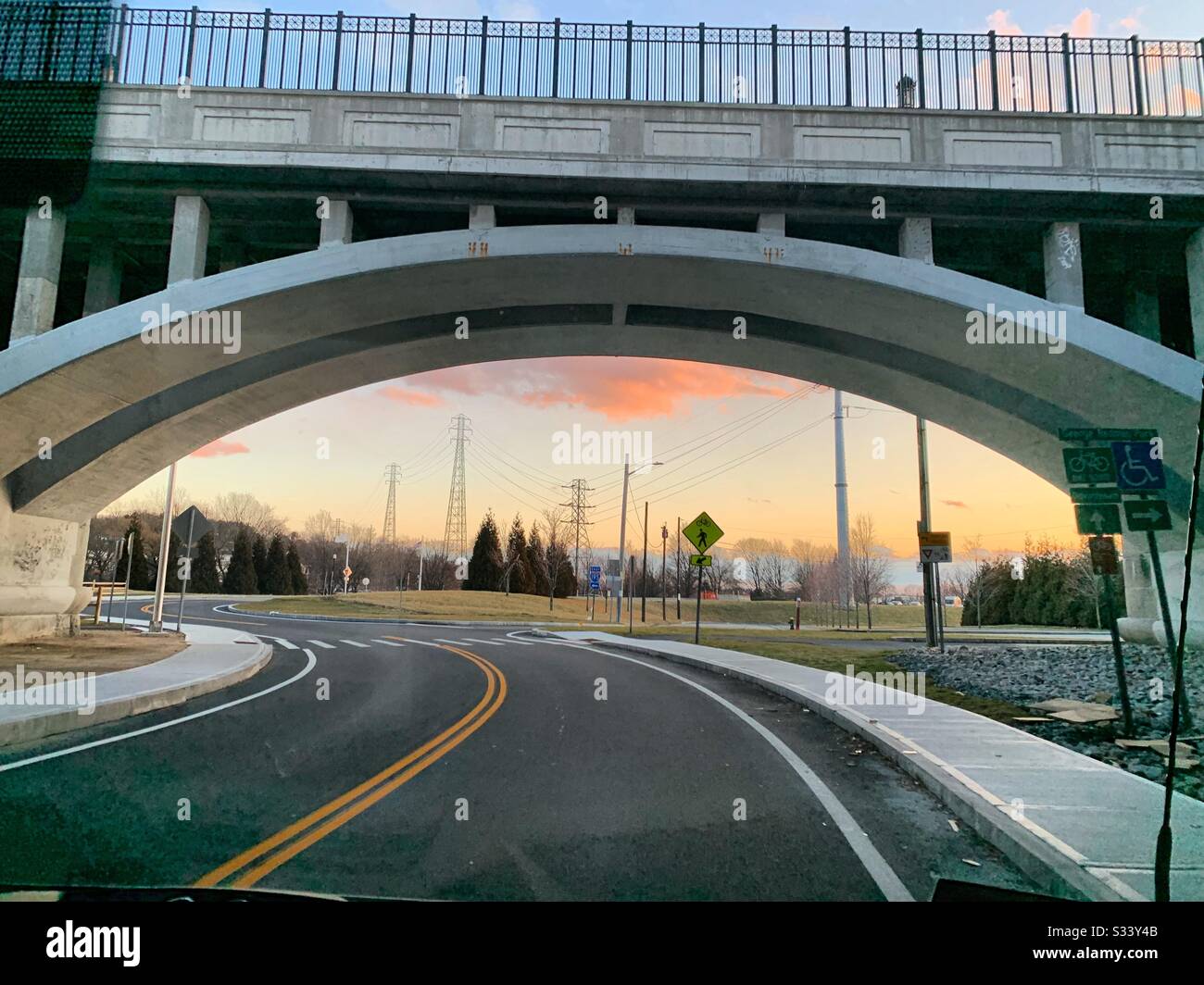 Driving under a bridge at sunset in winter, Providence, Rhode Island, United States - Smartphone Captured Stock Image