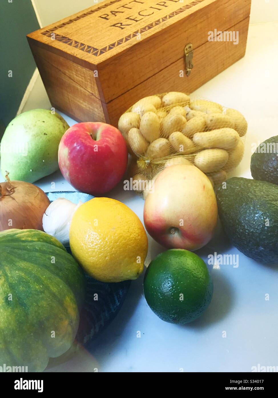 Still life of fruits and vegetables with a wooden recipe box on a  residential kitchen counter, USA - Smartphone Captured Stock Image Still life of fruits and vegetables with a wooden recipe box on a  residential kitchen counter, USA - Smartphone Captured Stock Image