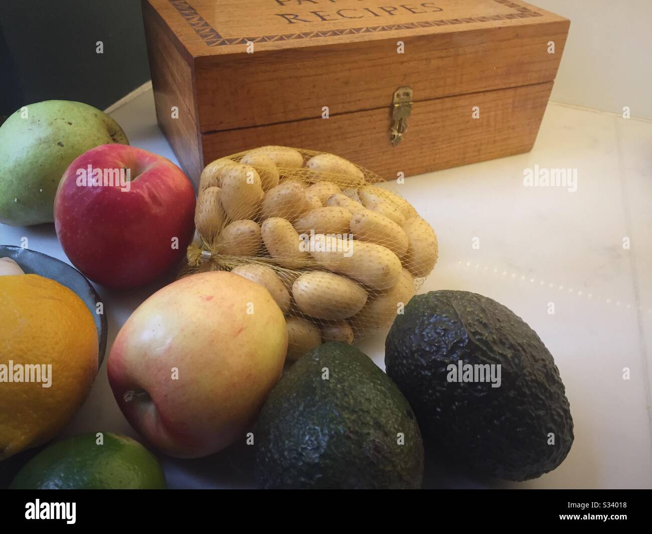 Still life of fruit and vegetables with a recipe box on a residential kitchen counter, USA Stock Photo
