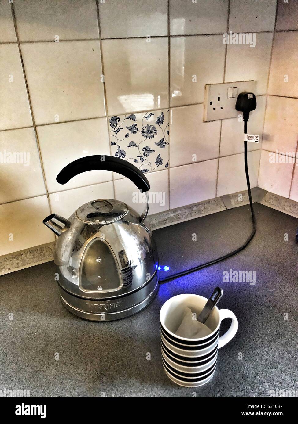 Boiling the kettle for a mug of tea Stock Photo