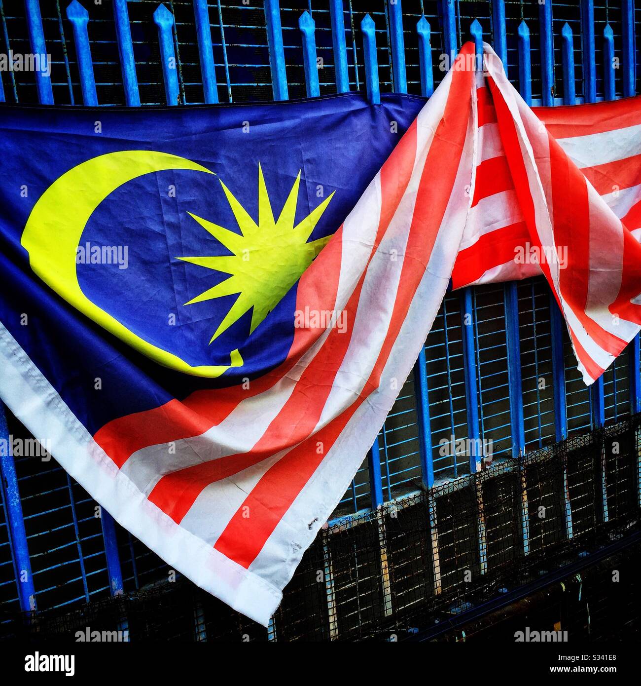 The Malaysian national flag outside a house in the Old Town of George Town, Penang, Malaysia - Smartphone Captured Stock Image