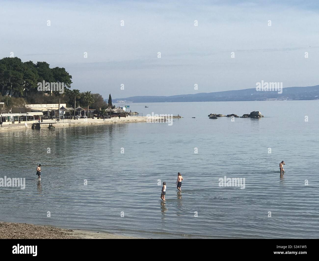 Citizens of Split, Croatia are fighting corona virus on their way: spending time at the beach at 17 degrees Celsius Stock Photo