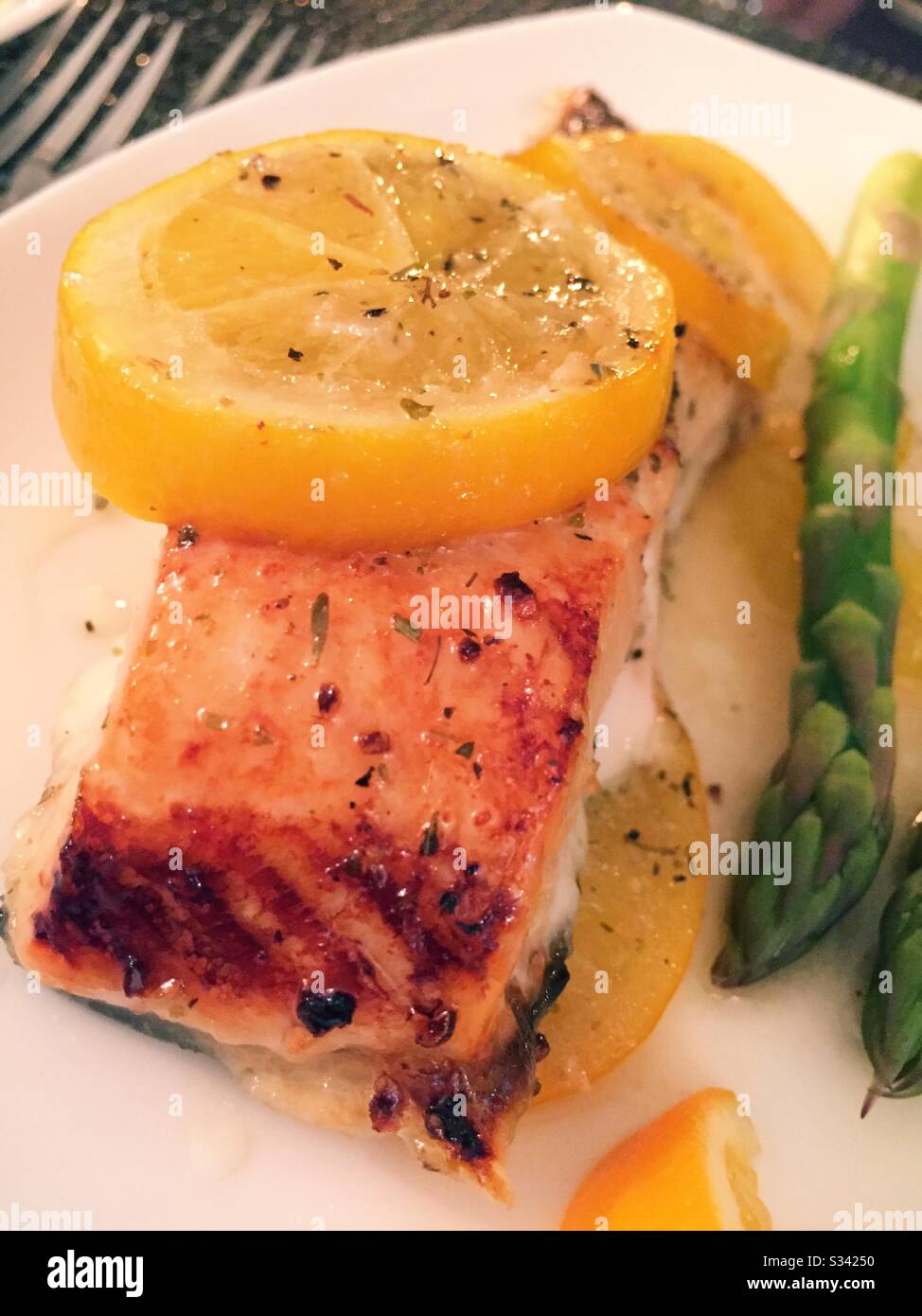 Close up of a gourmet dish a broiled salmon topped with Meyer lemon - Smartphone Captured Stock Image