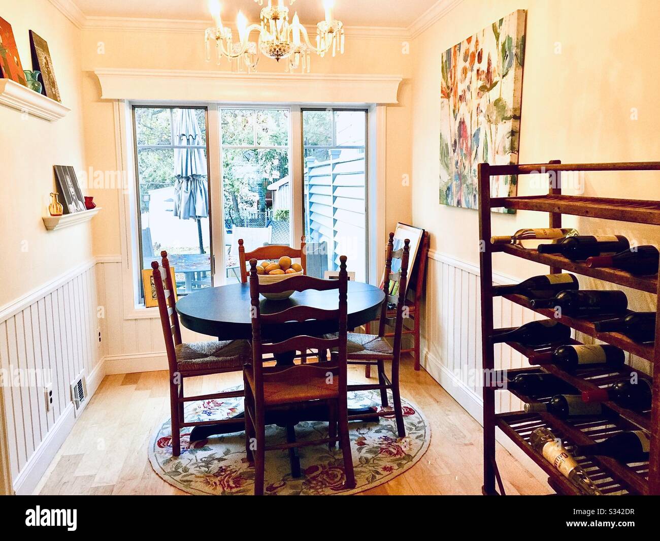 Small dining room decorating with big window and view to small city backyard - Smartphone Captured Stock Image