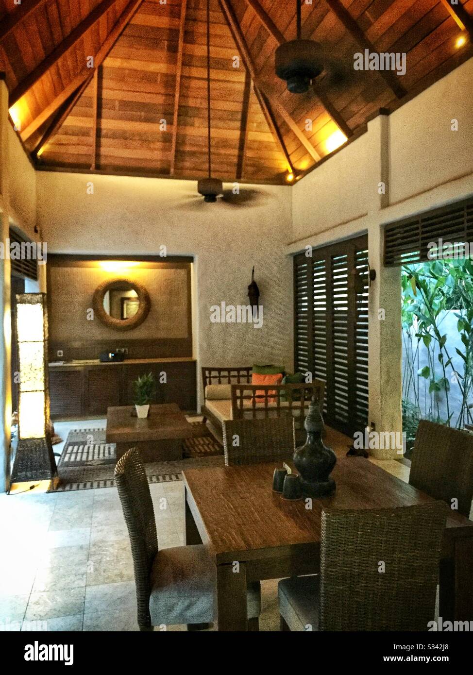 The al fresco lounge and dining area of a Garden Villa at The Banjaran Hotsprings Retreat near Ipoh, Malaysia - Smartphone Captured Stock Image