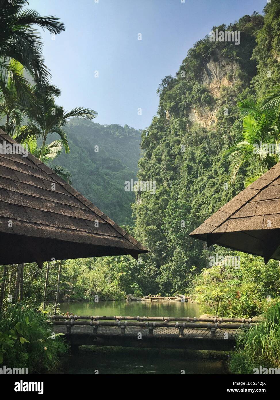 The man-made lake fed by geothermal hotsprings and the spectacular limestone karst landscape at The Banjaran Hotsprings Retreat near Ipoh, Malaysia Stock Photo