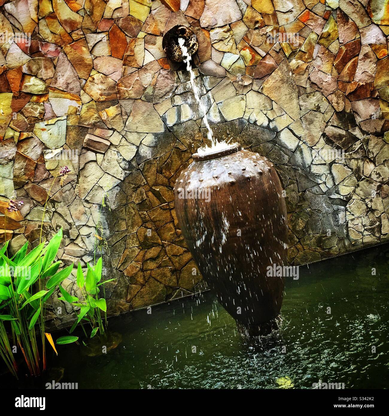Ponds, fountains, water features and aquatic plants are a feature of the landscaping at The Banjaran Hotsprings Retreat near Ipoh, Malaysia - Smartphone Captured Stock Image
