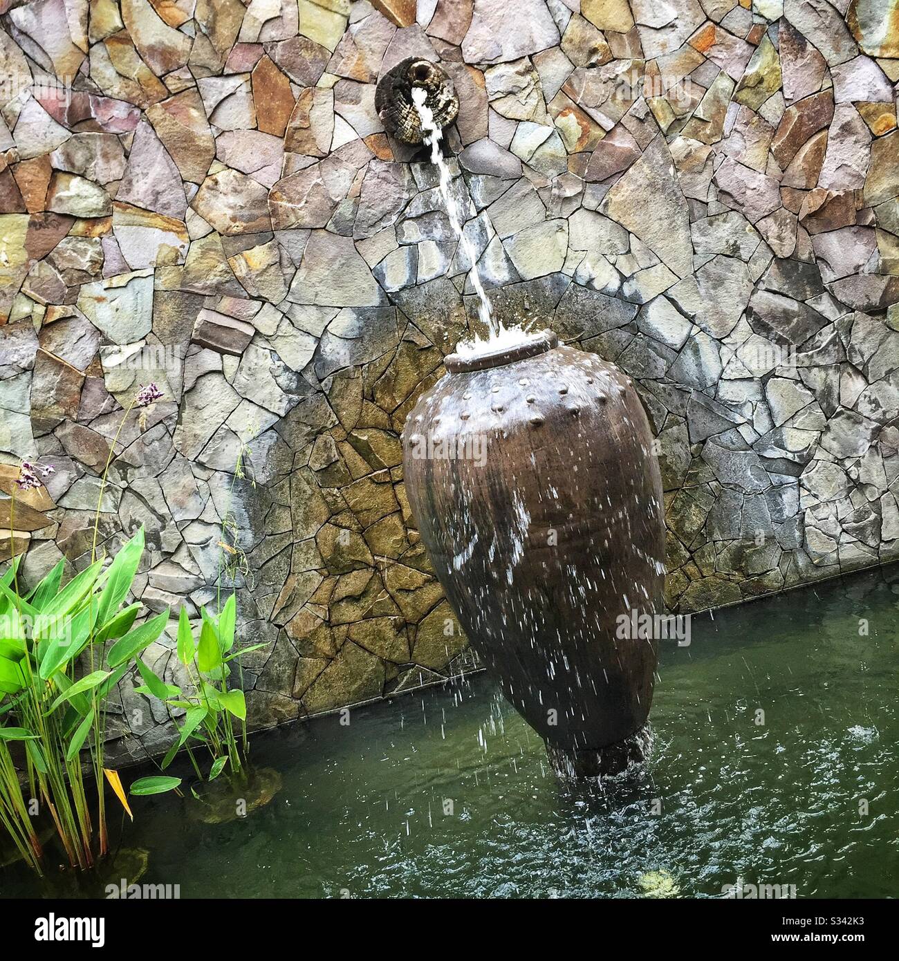 Ponds, fountains, water features and aquatic plants are a feature of the landscaping at The Banjaran Hotsprings Retreat near Ipoh, Malaysia - Smartphone Captured Stock Image