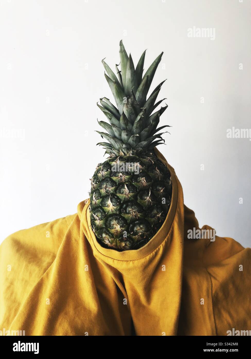 Pineapple wearing a a yellow t-shirt, humorous image - Smartphone Captured Stock Image