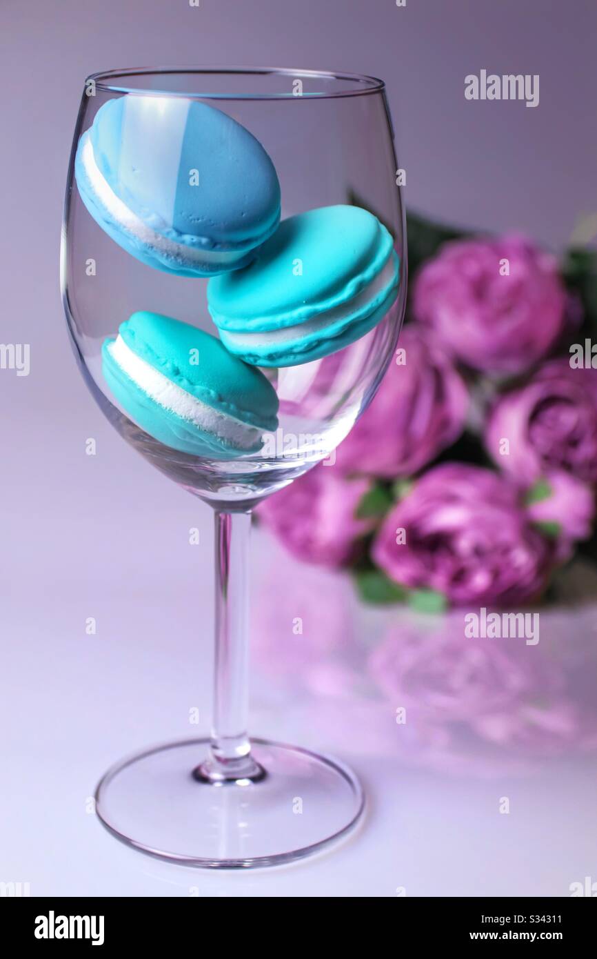 Three blue macaroons in wine glass Stock Photo