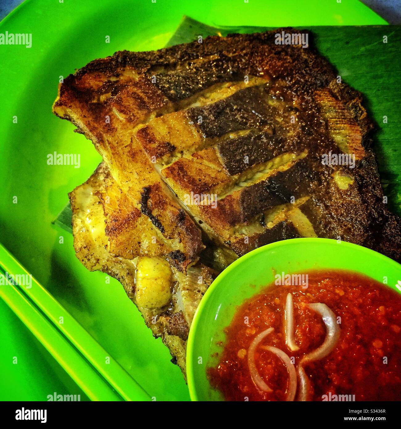 Grilled swordfish and chili sauce at a street restaurant in Jalan Alor, a hawker food market in Bukit Bintang, Kuala Lumpur, Malaysia - Smartphone Captured Stock Image