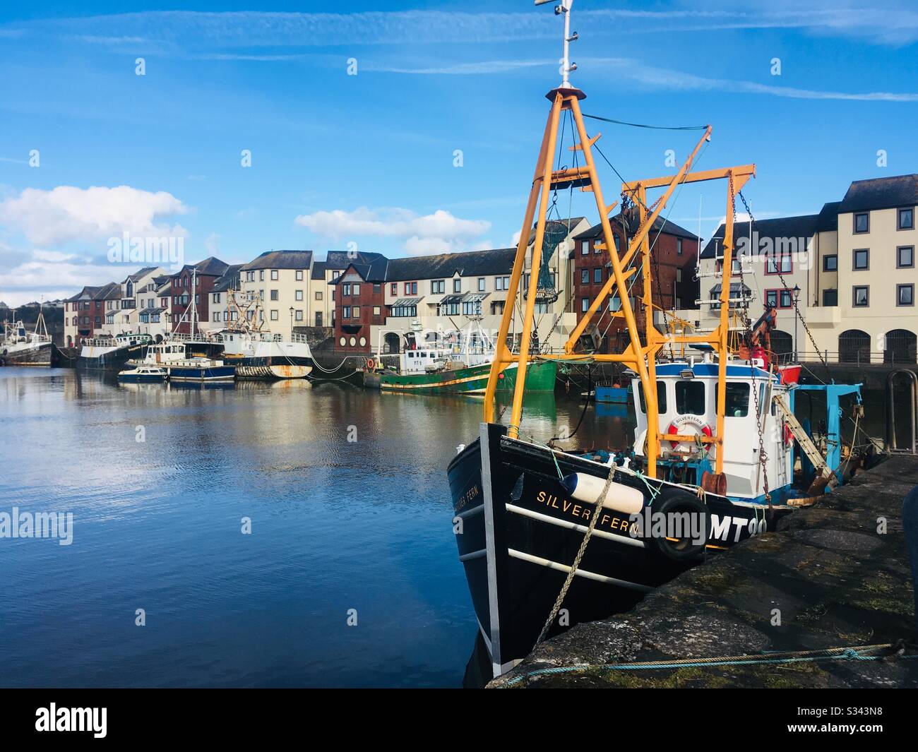 Fishing boat moored in the harbour at Maryport, Cumbria, England Stock Photo