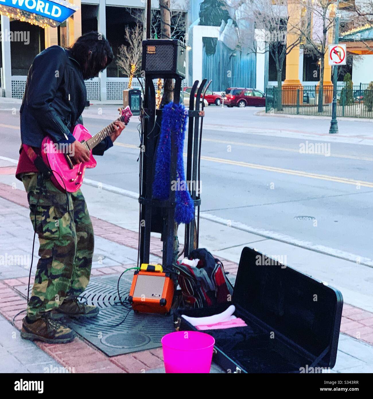 Street musician with a hot pink electric guitar, Downtown Reno, Nevada, United States - Smartphone Captured Stock Image