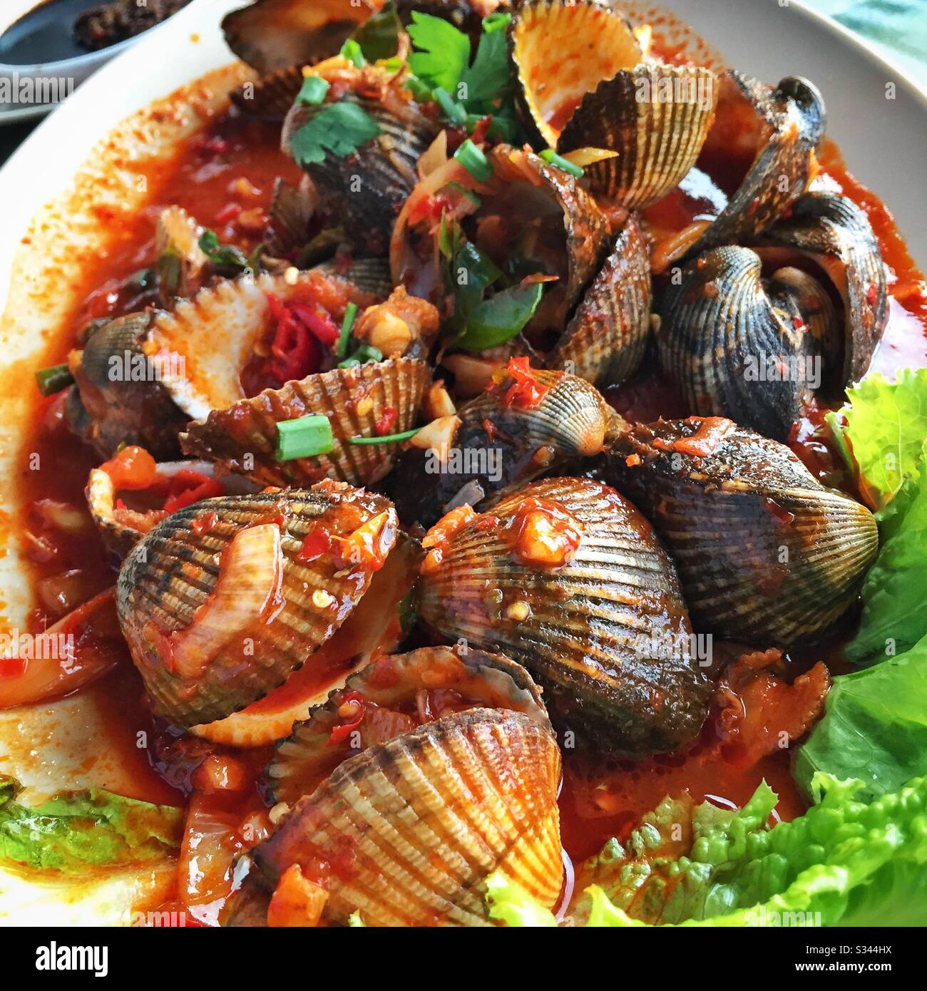Clams in chili sauce, a dish at D'Perahu Seafood restaurant, Kuala 