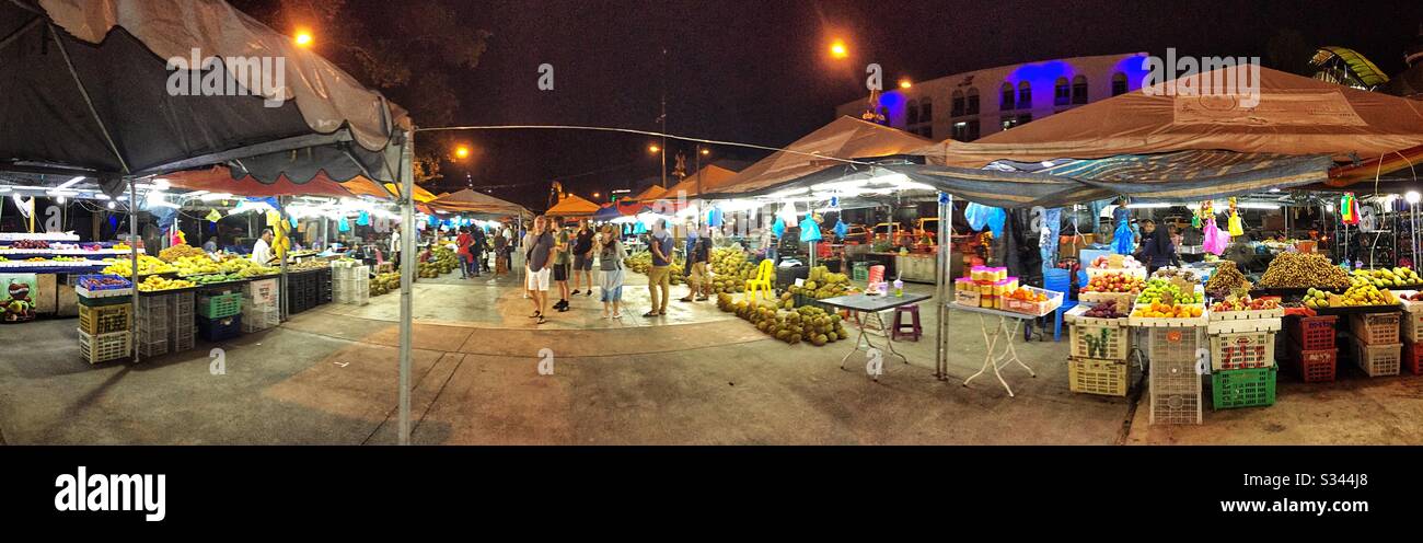 Durian and other local tropical fruit for sale at a night street market in Kuala Terengganu, Malaysia - Smartphone Captured Stock Image