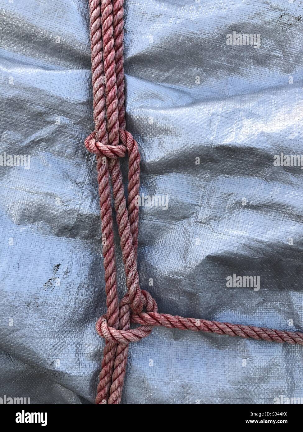 Rope knots over a tarp. - Smartphone Captured Stock Image