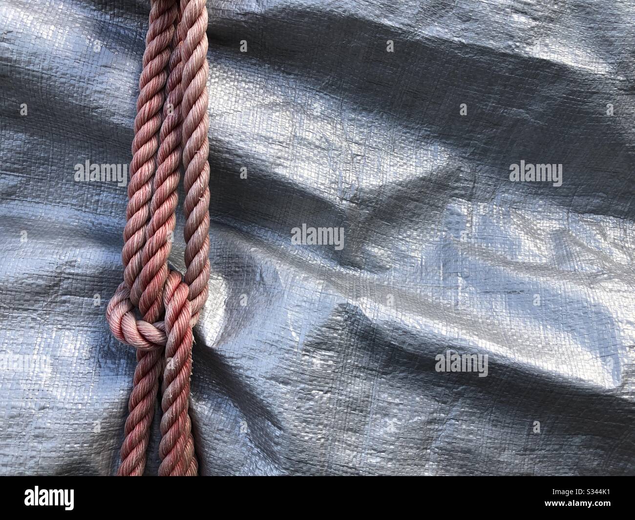 Rope knots over a tarp Stock Photo Alamy