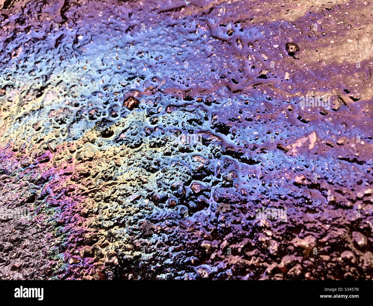 Oil spilled on pavement. - Smartphone Captured Stock Image