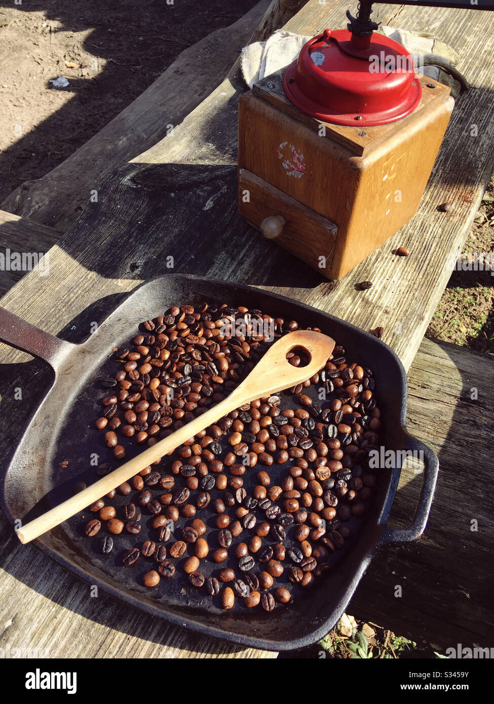 Roasted coffee Next to a Vintage coffee grinder in a Vintage iron ...