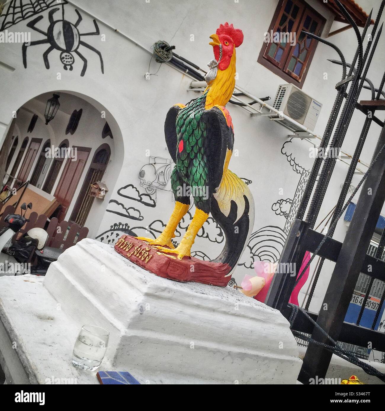 Painted statuette of a rooster outside a restaurant in George Town, Penang, Malaysia - Smartphone Captured Stock Image
