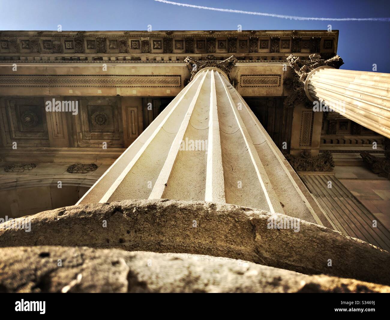 A low angle shot, looking straight up a 19th century stone column. Architectural details of Wellington Arch, London - Smartphone Captured Stock Image
