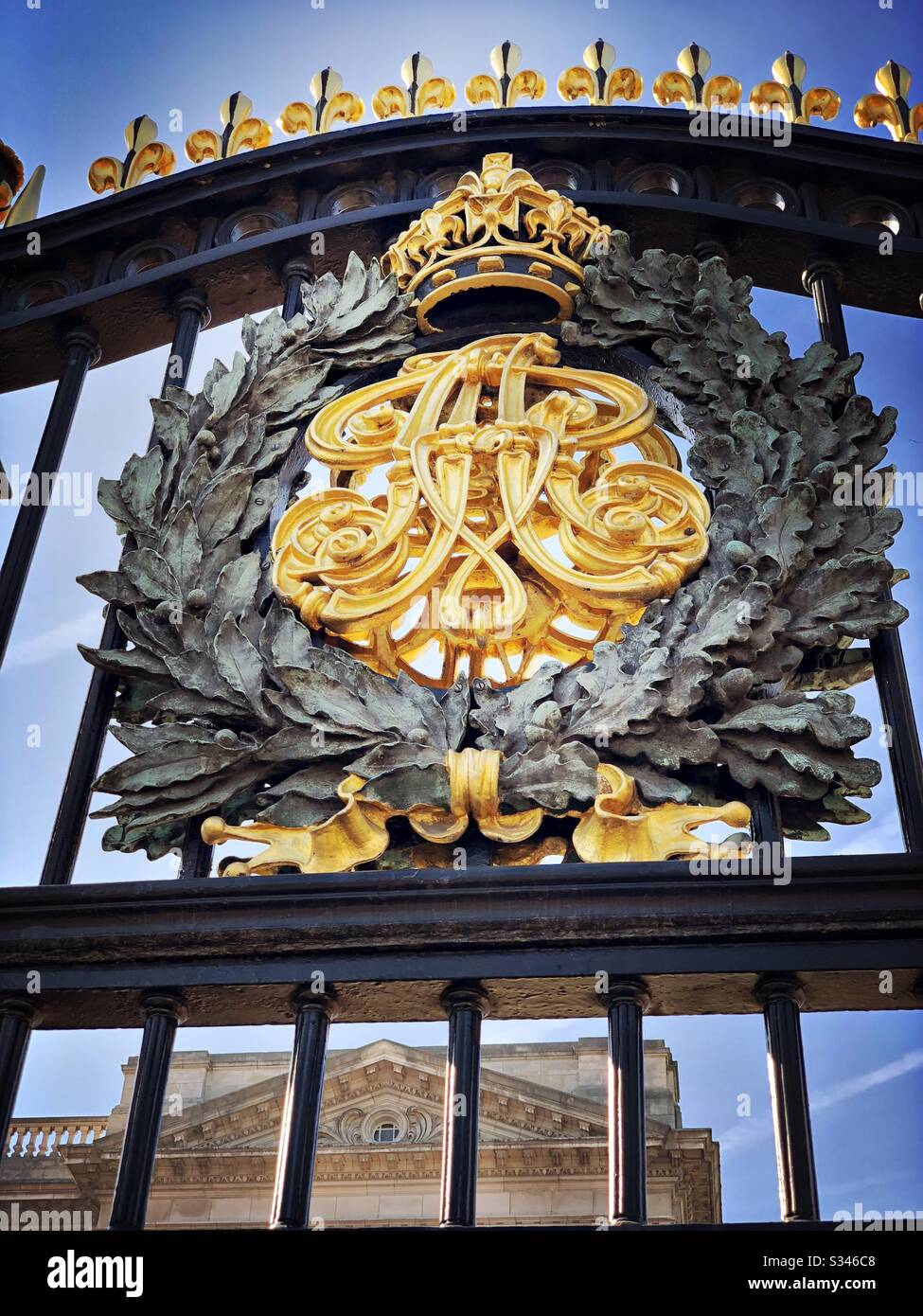 A close up shot on the gold leaf coat of arms on the railings at the entrance gates to Buckingham Palace, London - Smartphone Captured Stock Image