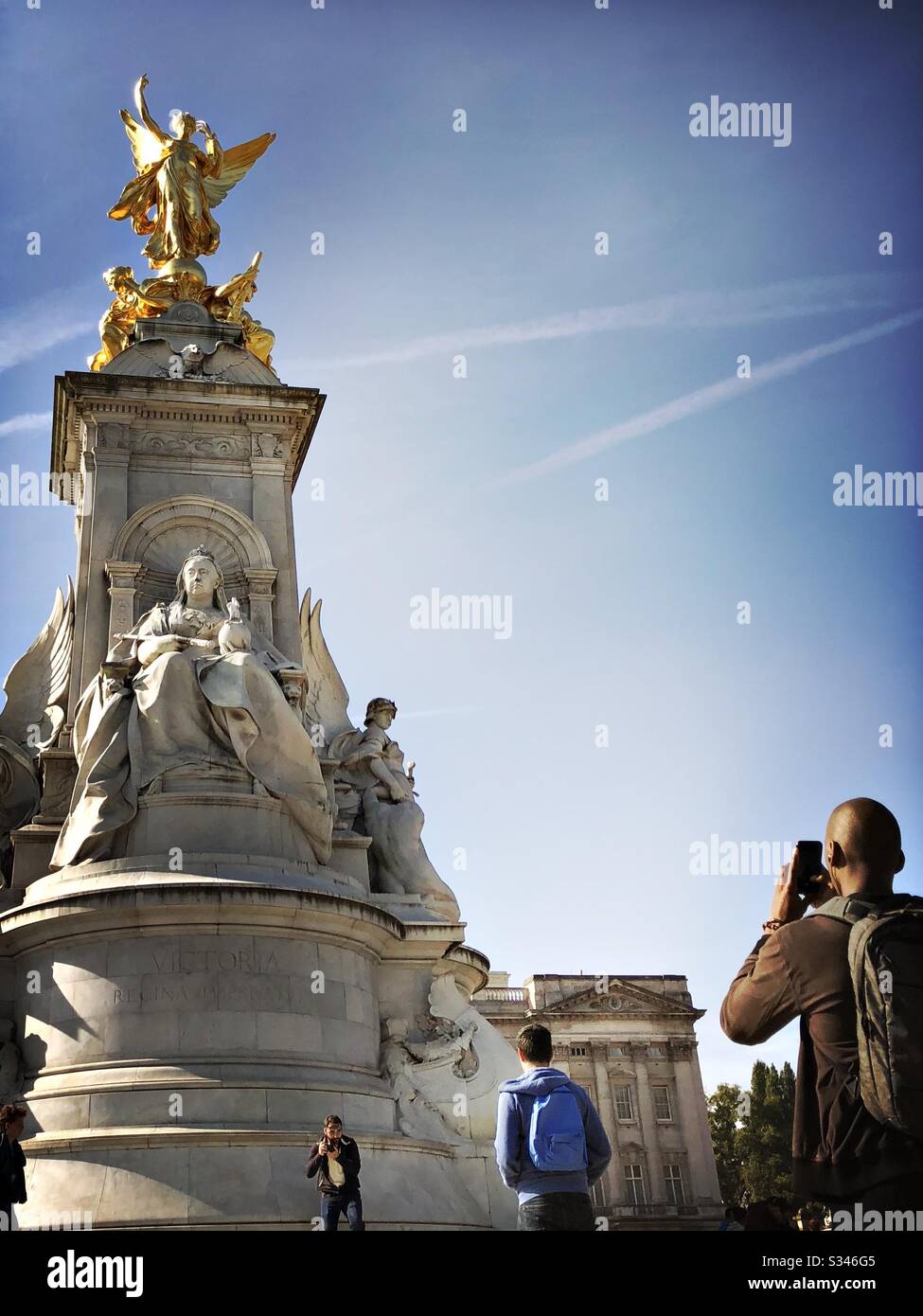 A close up shot of an African tourist taking a photograph on a smartphone of the Victoria Memorial Monument, London - Smartphone Captured Stock Image