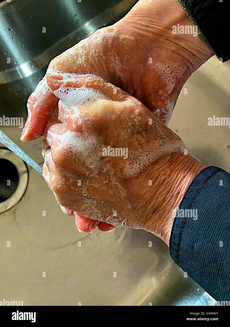 Man washing hands - Smartphone Captured Stock Image