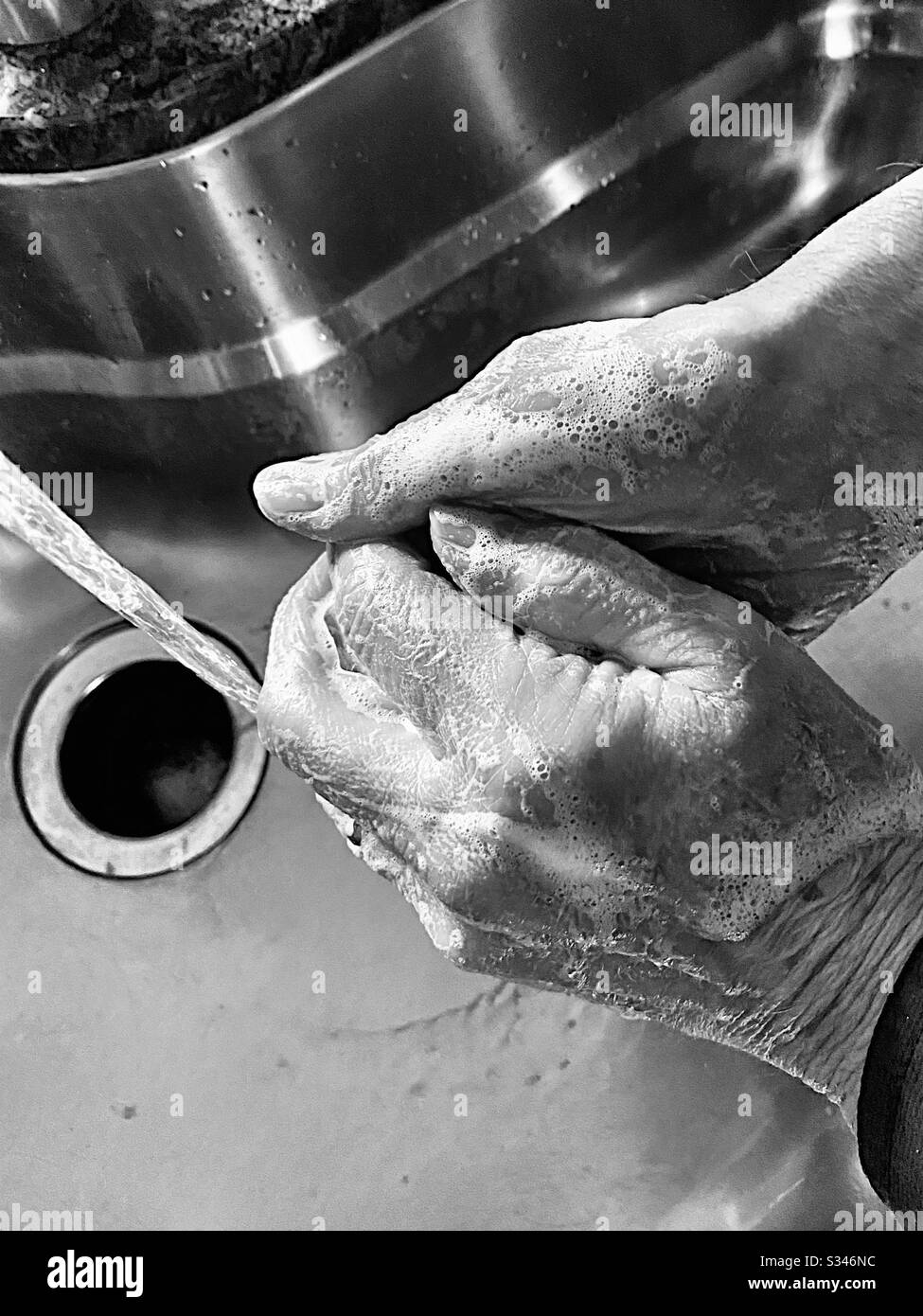Man washing hands, black and white 2 - Smartphone Captured Stock Image