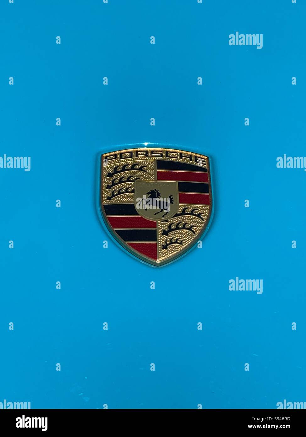 Porsche logo on a baby blue hood Stock Photo