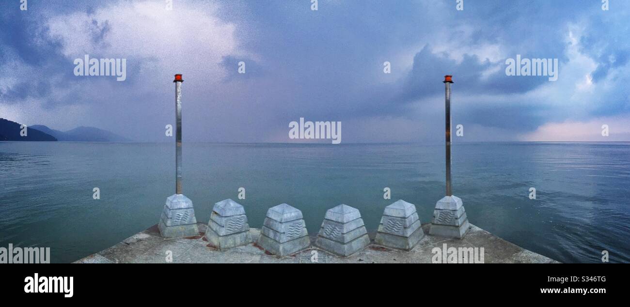 A morning rain squall over the ocean at Batu Ferringhi, Penang, Malaysia - Smartphone Captured Stock Image