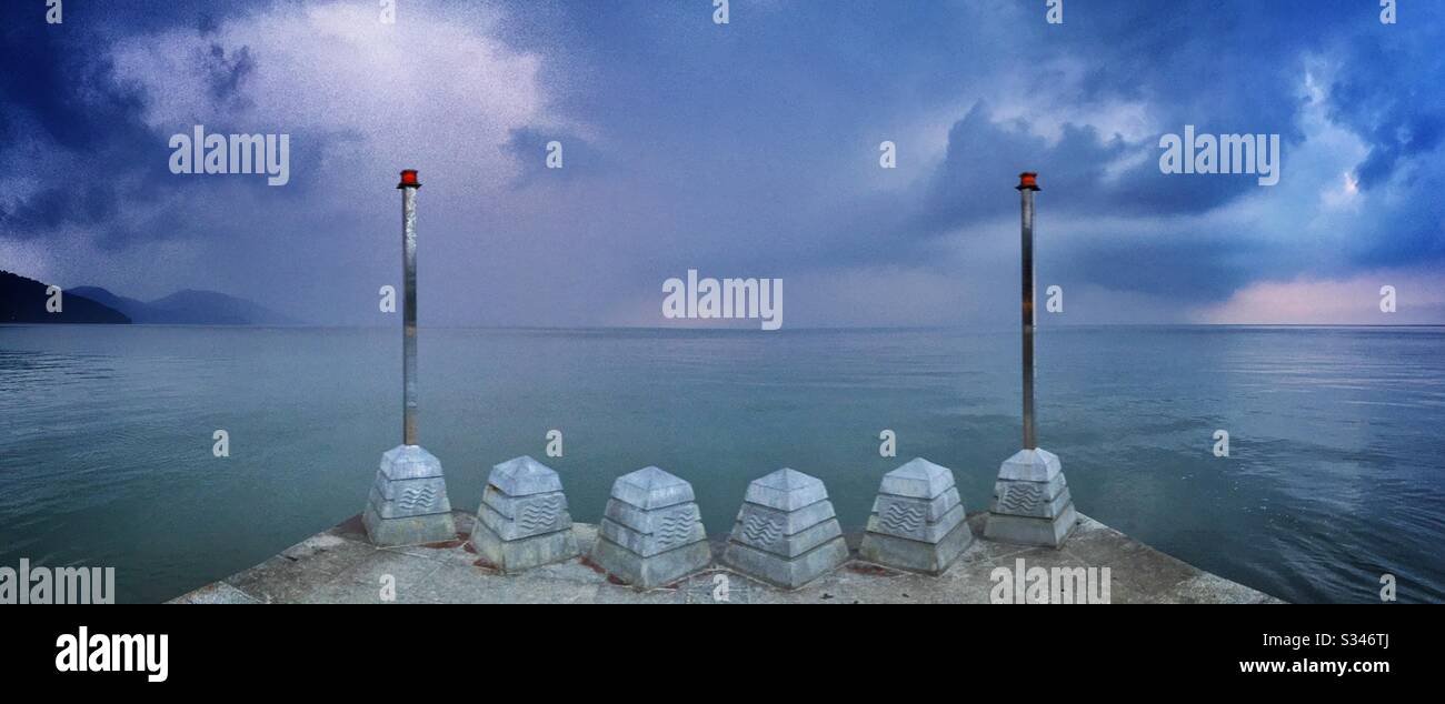 A morning rain squall over the ocean at Batu Ferringhi, Penang, Malaysia - Smartphone Captured Stock Image